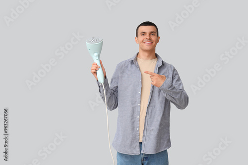 Young man pointing at steam...