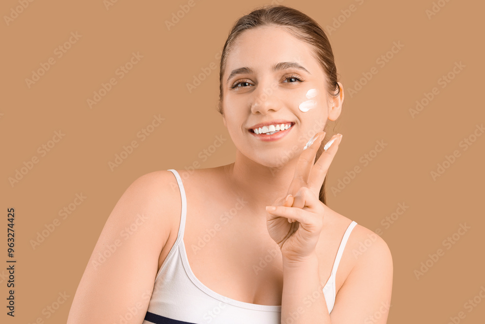 Beautiful young woman with cosmetic cream on brown background Beautiful young woman with cosmetic cream on brown background