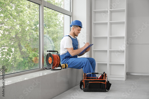 Male contractor writing on ...