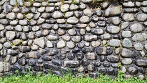 Stone wall built from natural stone washed by rain photo