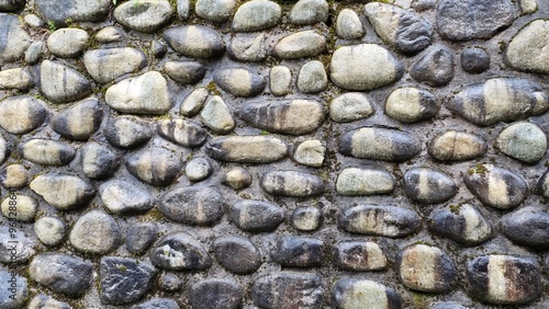 Stone wall built from natural stone washed by rain photo