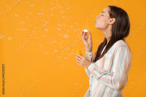 Young woman blowing soap bu...