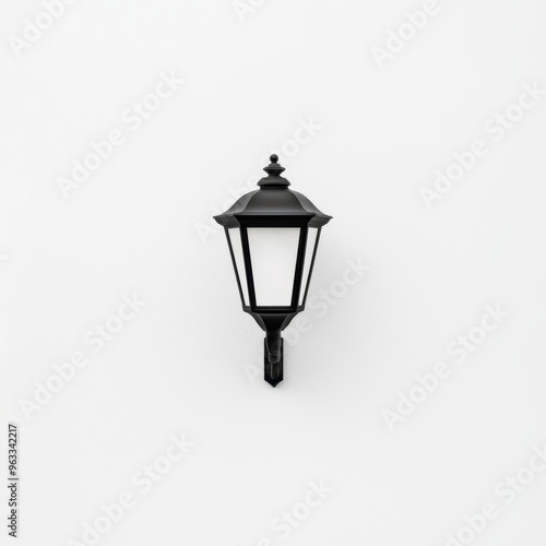 A black lamp is hanging on a white wall photo