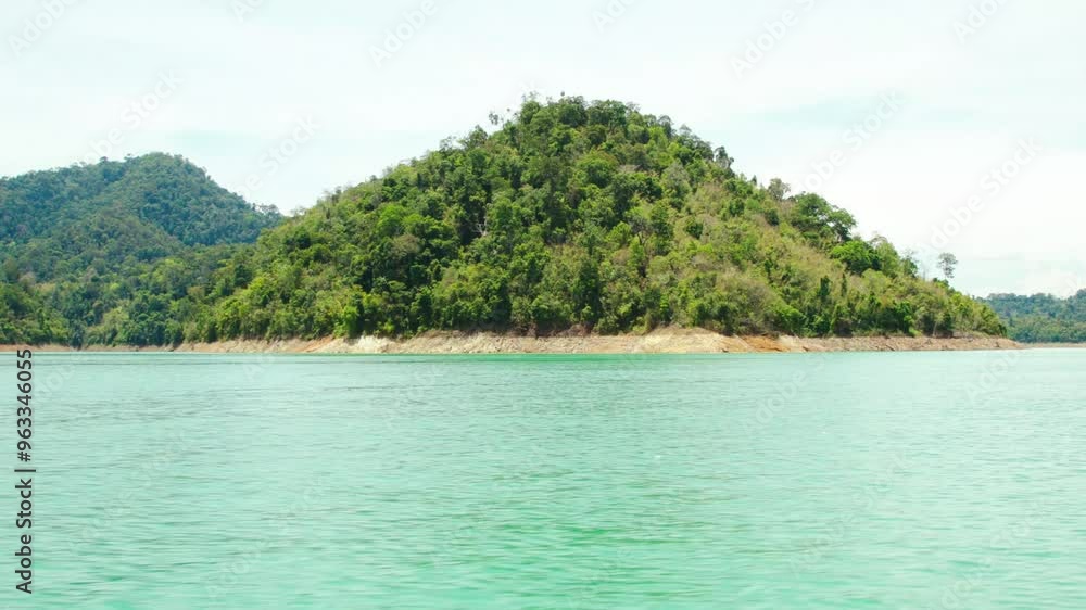 Travelling around an island on the Cheow Lan lake in Thailand Travelling around an island on the Cheow Lan lake in Thailand