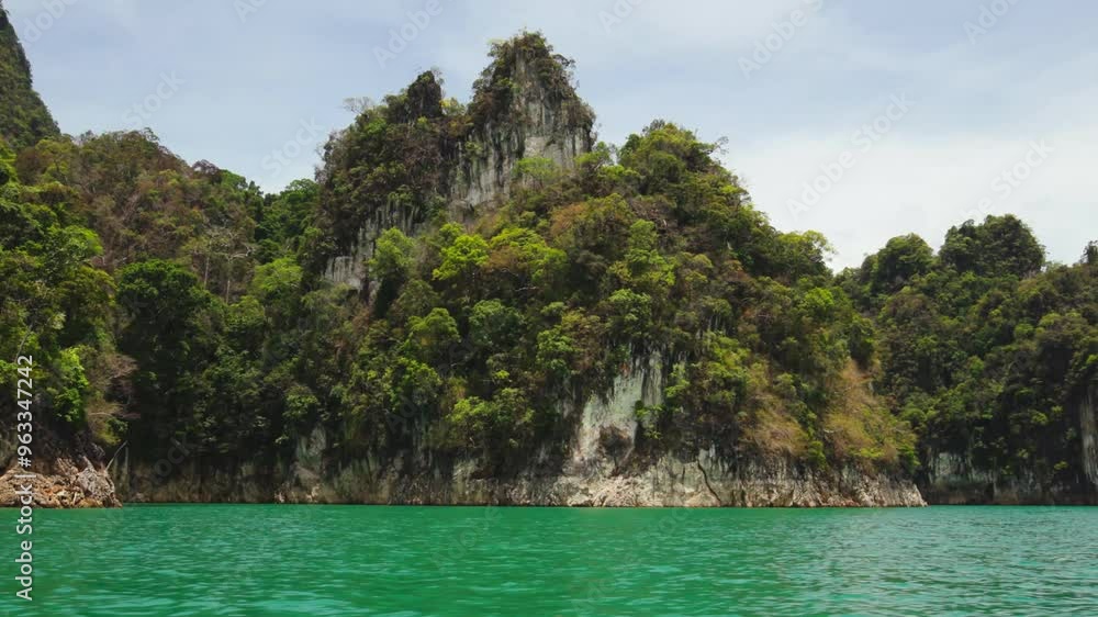 Travelling around rocks on the Cheow Lan lake in Thailand Travelling around rocks on the Cheow Lan lake in Thailand