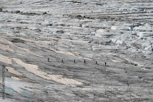 6 walkers in silhouette crossing a glacier in Chamonix