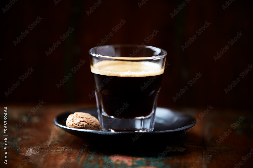 Coffee in glass cup on dark background. Close up. Copy space. Coffee in glass cup on dark background. Close up. Copy space.