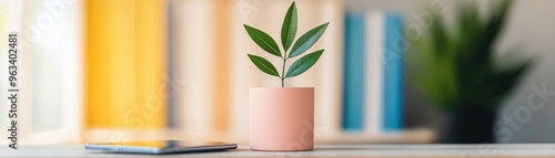 A stylish indoor plant in a pink pot adds a touch of greenery to a modern workspace, enhancing productivity and relaxation.