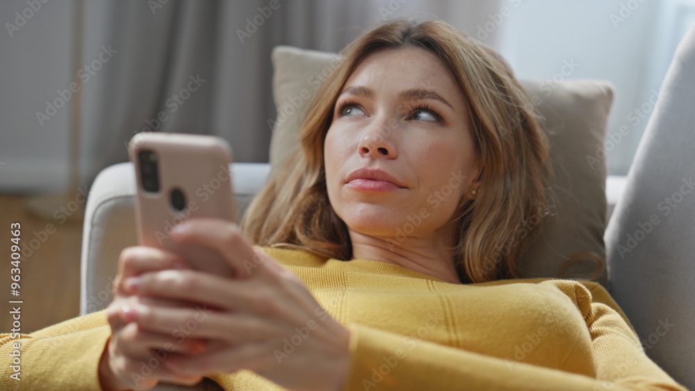 Thinking woman creating sms smartphone chilling couch at weekend home closeup Thinking woman creating sms smartphone chilling couch at weekend home closeup
