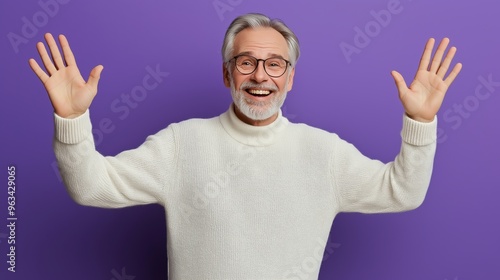 A man in a white sweater is smiling and waving his hands. The image has a happy and friendly mood