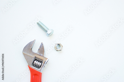 Wrench, hexagonal head stainless steel bolt and lock nut fastener isolated on white background with space for copy. industry hardware, handyman tool, home improvement, repair and maintenance equipment photo