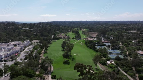 Aerial view of a luxury golf course in Rancho Santa Fe with views of the blue sky and luxury homes surrounding the area photo