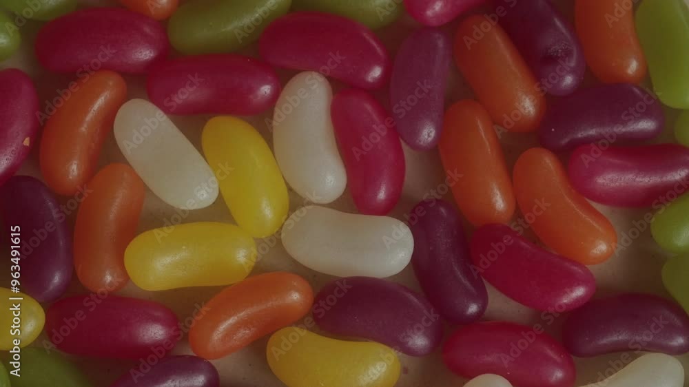 Colourful jelly beans background rotating macro. Unhealthy eating. Candy and sweet food. Colourful jelly beans background rotating macro. Unhealthy eating. Candy and sweet food.