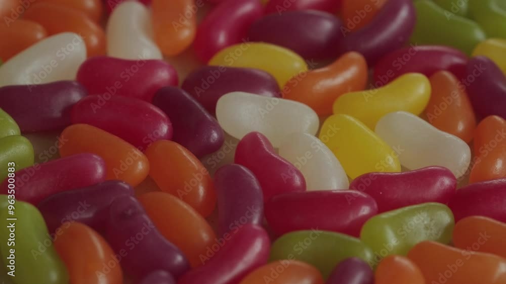 Colourful jelly beans background rotating macro. Unhealthy eating. Candy and sweet food. Colourful jelly beans background rotating macro. Unhealthy eating. Candy and sweet food.