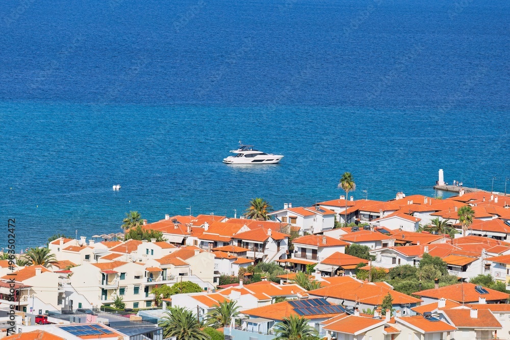 Fototapeta premium view of town and boat on the sea from hill in pefkochori, greece
