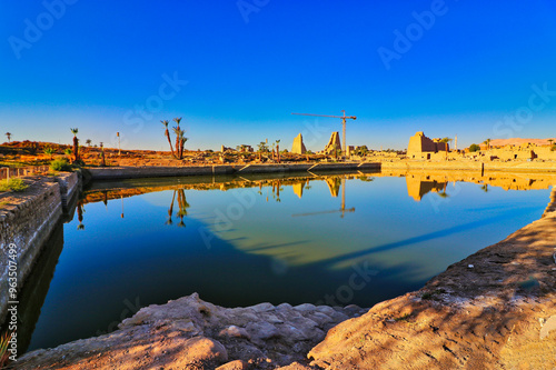 Sacred lake of Karnak used by the priest for purification baths and ceremonies beyond the outermost gate at Karnak temple complex dedicated to Amun-Re in Luxor,Egypt photo