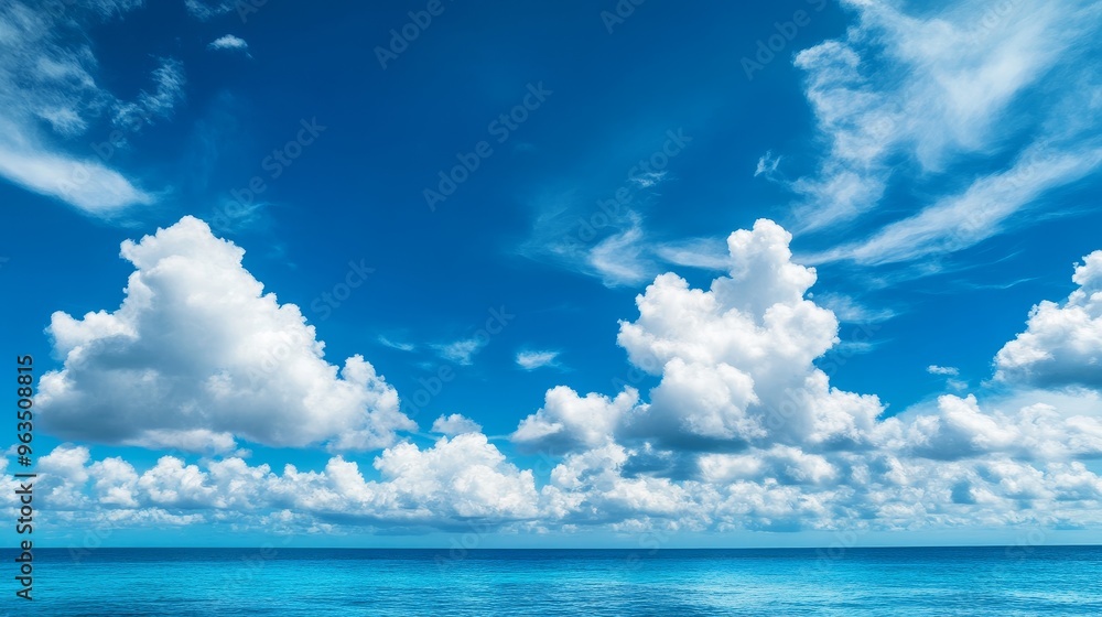 A breathtaking panoramic view of a clear blue sky dotted with fluffy white clouds, contrasting beautifully with the tranquil, azure waters of the ocean below. The scene evokes feelings of peace, tran A breathtaking panoramic view of a clear blue sky dotted with fluffy white clouds, contrasting beautifully with the tranquil, azure waters of the ocean below. The scene evokes feelings of peace, tran