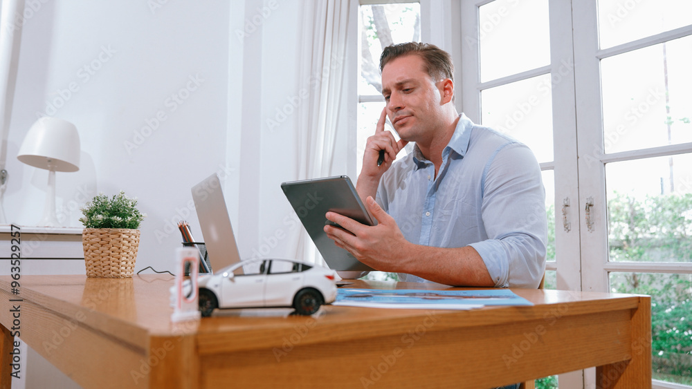 Stressed and frustrated car design engineer put his head in his hand after discover flaw in vehicle design, working at home for automotive business while trying to find solution. Synchronos Stressed and frustrated car design engineer put his head in his hand after discover flaw in vehicle design, working at home for automotive business while trying to find solution. Synchronos