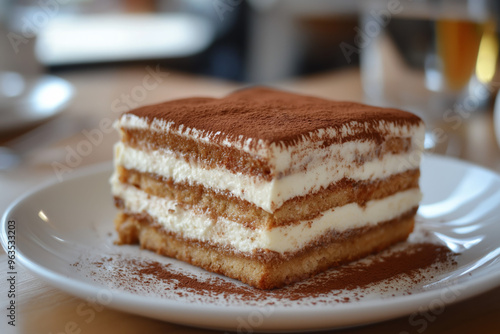 Classic Tiramisu Slice with Cocoa Dusting on a White Plate