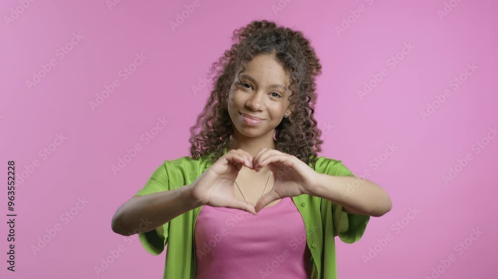 Cute african american teenager girl showing sign of shape heart. Positive lady on pink. Love. Women health, volunteering, charity donation, gratitude symbol, flirting concept Cute african american teenager girl showing sign of shape heart. Positive lady on pink. Love. Women health, volunteering, charity donation, gratitude symbol, flirting concept