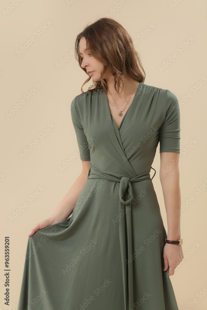 Serie of studio photos of young female model in green viscose wrap dress.