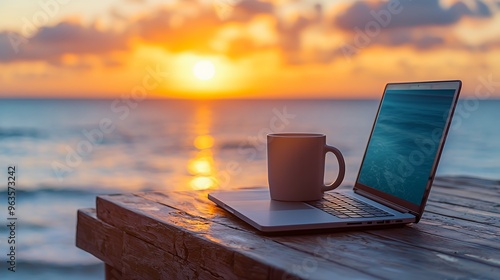 Wallpaper Mural Laptop and coffee mug on wooden table overlooking the ocean at sunset. Torontodigital.ca