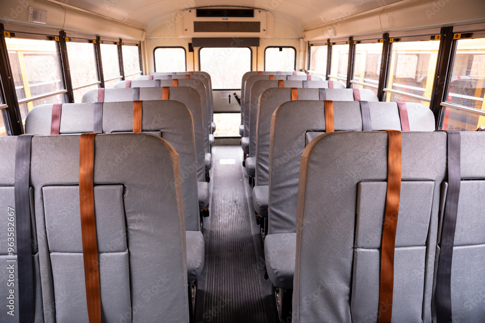 Interior of empty school bus with seat belts Interior of empty school bus with seat belts