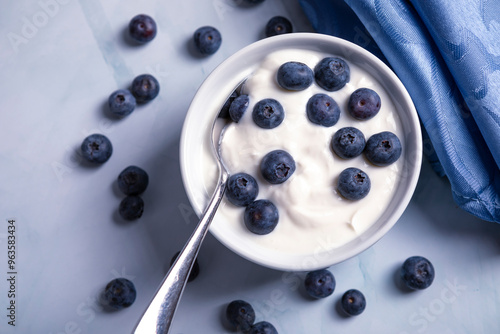 Tasty liquid texture of yogurt with blueberry. Creamy dairy product.