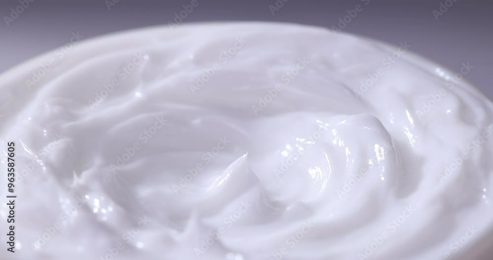 White cream swirl, rotating texture, White cream background, close up. Dairy product. Delicious organic creamy yogurt. Milk cream. White cream swirl, rotating texture, White cream background, close up. Dairy product. Delicious organic creamy yogurt. Milk cream.