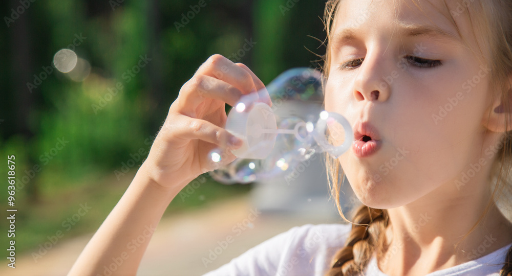 little girl is blowing a soap bubbles little girl is blowing a soap bubbles
