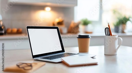 Laptop and notebook on a kitchen table, remote work from home, casual and comfortable setup