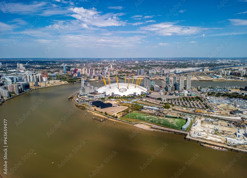 Obraz premium The drone aerial view of Greenwich Peninsula and River Thames. The Greenwich Peninsula is an area of Greenwich in South East London, England.
