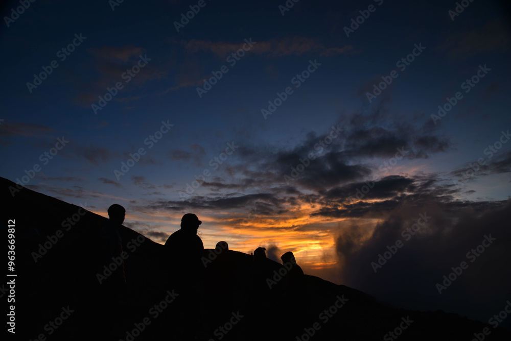 Fototapeta premium silhouette of a man on a mountain top