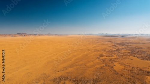 A vast expanse of desert land slowly encroaching on previously fertile areas, symbolizing the spread of desertification as a result of changing climate conditions. photo