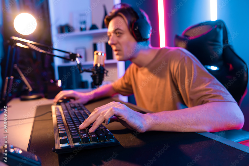 Host channel of gaming smart streamer playing online game to be winner, wearing headphone with viewers live steaming on media social online for selected team competition at neon light room. Pecuniary. Host channel of gaming smart streamer playing online game to be winner, wearing headphone with viewers live steaming on media social online for selected team competition at neon light room. Pecuniary.