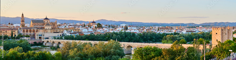 Panoramic view of the Mosque-Cathedral across the Calahorra Tower and the Roman Bridge over the Guadalquivir River, Cordoba, Andalusia, Spain. Panoramic view of the Mosque-Cathedral across the Calahorra Tower and the Roman Bridge over the Guadalquivir River, Cordoba, Andalusia, Spain.