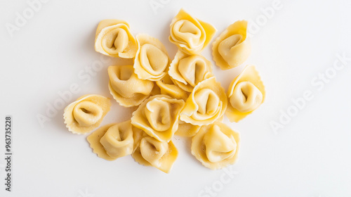tortellini with prosciutto and cream sauce with a light dusting of nutmeg against an isolated white background