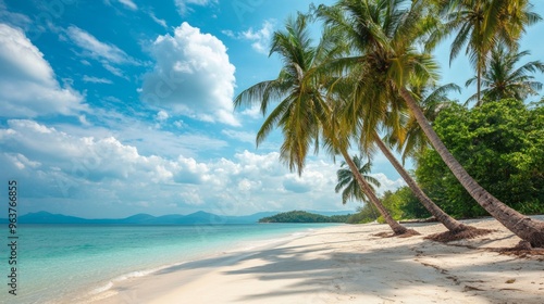 Tropical sea beach scene with clear turquoise water, white sandy shore and palm trees under a bright blue sky on a sunny day