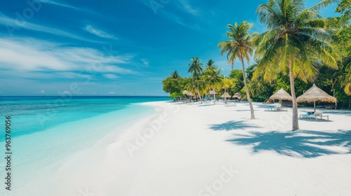 Tropical sea beach scene with clear turquoise water, white sandy shore and palm trees under a bright blue sky on a sunny day