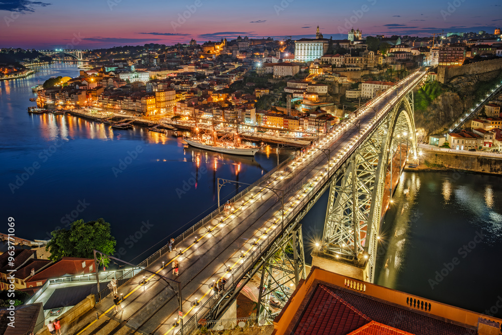 View of illuminated Porto city and Douro river and Dom Luis bridge I from famous tourist viewpoint Miradouro da Serra do Pilar in evening twilight. Porto, Vila Nova de Gaia, Portugal View of illuminated Porto city and Douro river and Dom Luis bridge I from famous tourist viewpoint Miradouro da Serra do Pilar in evening twilight. Porto, Vila Nova de Gaia, Portugal