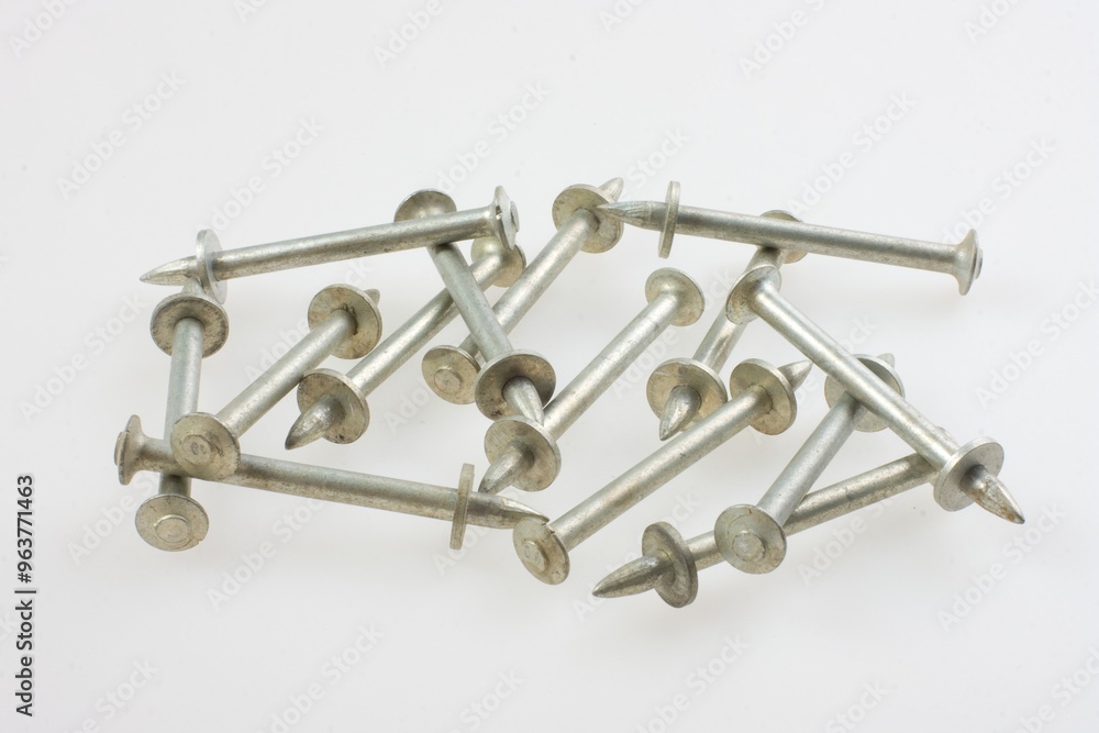 Many different fasteners and dowels on light blue background, flat lay Many different fasteners and dowels on light blue background, flat lay