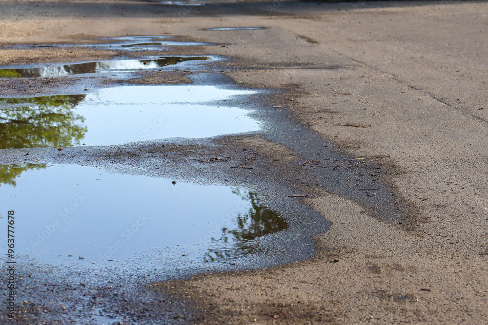 rain filled pot holes on road rain filled pot holes on road