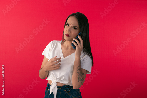 Young woman with smartphone simulating use with facial expressions. photo