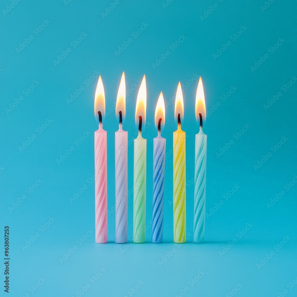 Colorful Row of Lit Birthday Candles on a Blue Background
Colorful Row of Lit Birthday Candles on a Blue Background