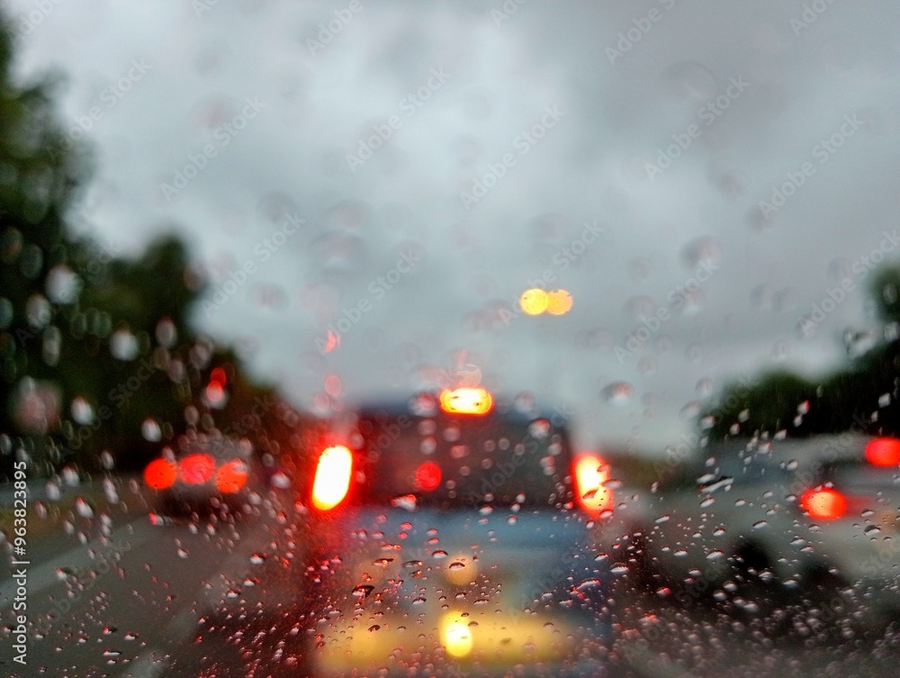 rain drops on car window with view of light on the the street rain drops on car window with view of light on the the street