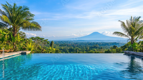 Bali Tropical Paradise: Lush Greenery, Serene Infinity Pool Reflecting Blue Sky, and Distant Volcano View.