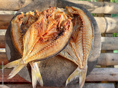 Dried salted fish background. Fusilier fish also known as "ikan sulit" in Malay.  Stock photo.