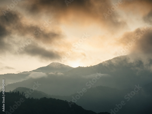 a mountain range with a sunset in the background.