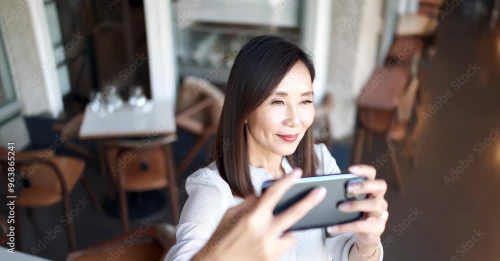 Asian woman recording a selfie video enjoying her time in the cafe Asian woman recording a selfie video enjoying her time in the cafe