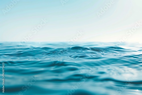 Tranquil water surface with gentle waves under a bright blue sky, evoking peace and serenity in nature.